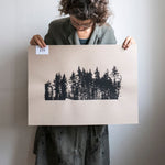 Screen printed Finnish pines on brown paper.